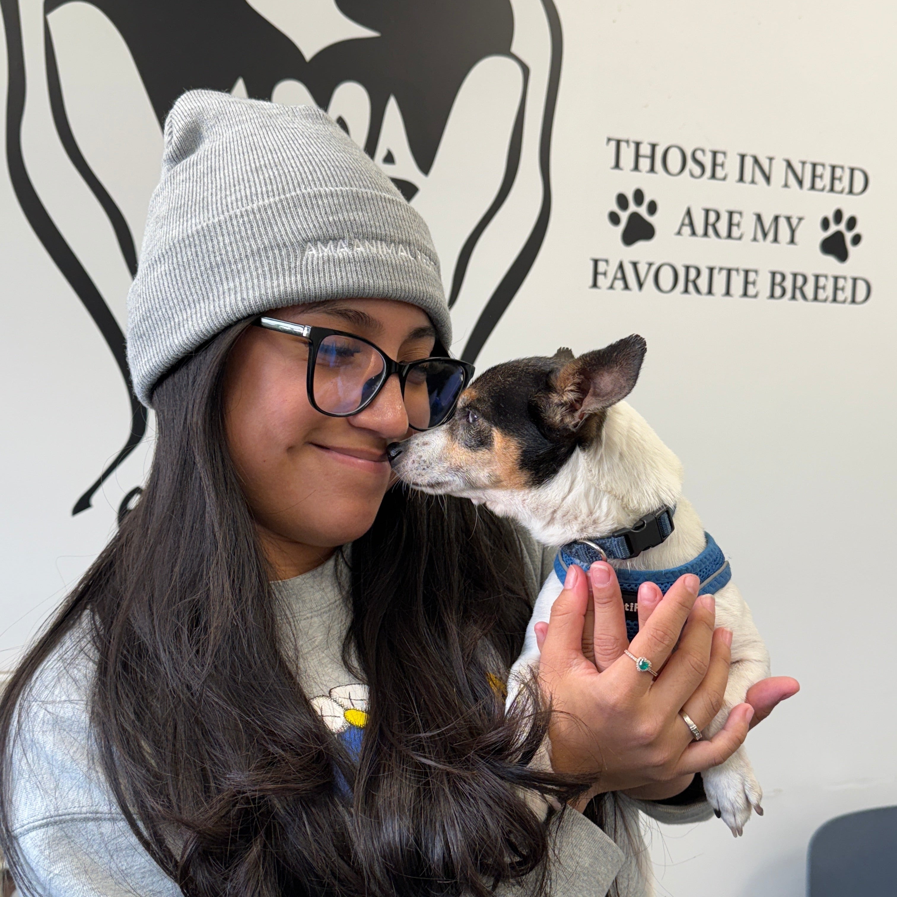 Person wearing a gray beanie with AMA Animal rescue on the front